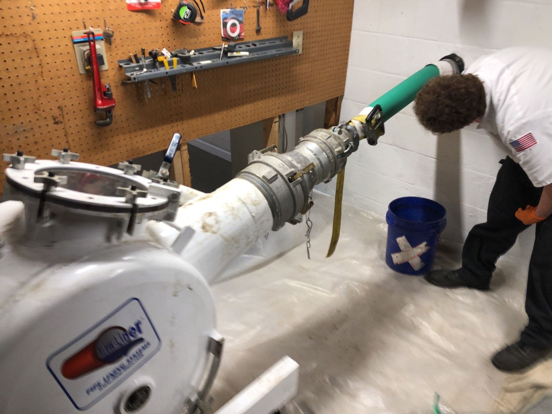 Plumber unclogging blocked shower drain with hydro jetting Plumber unclogging blocked shower drain with hydro jetting