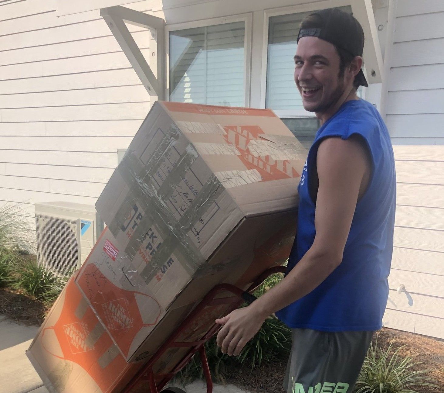 Makin Moves crew member wheeling boxes on a dolly during a Myrtle Beach move