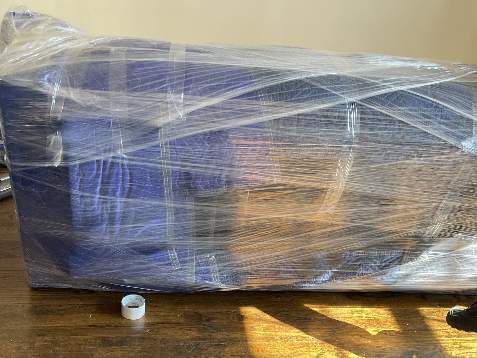 Couch shrink-wrapped and padded for protection by Makin Moves movers