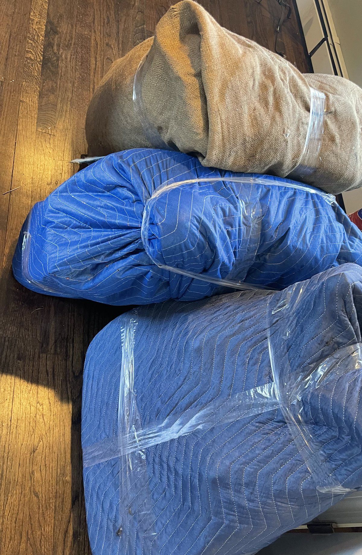 Furniture wrapped in moving pads and stacked for transport