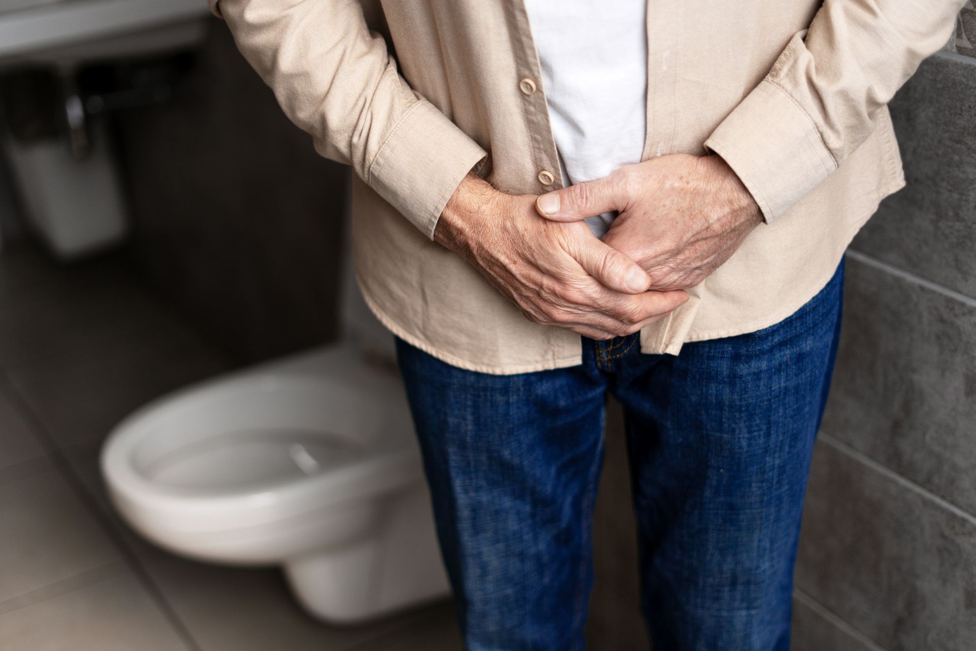 A man is experiencing bladder pain. A man is experiencing bladder pain.