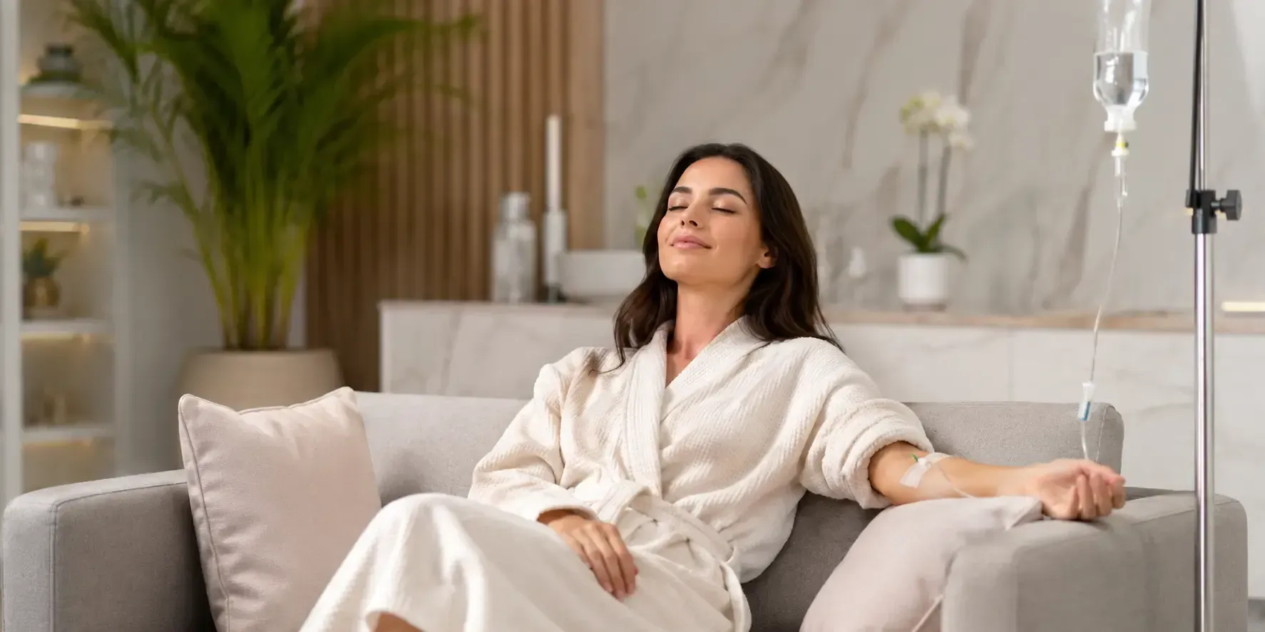 Patient relaxing on sofa receiving Anti Aging and Beauty IV drip for radiant skin wellness care