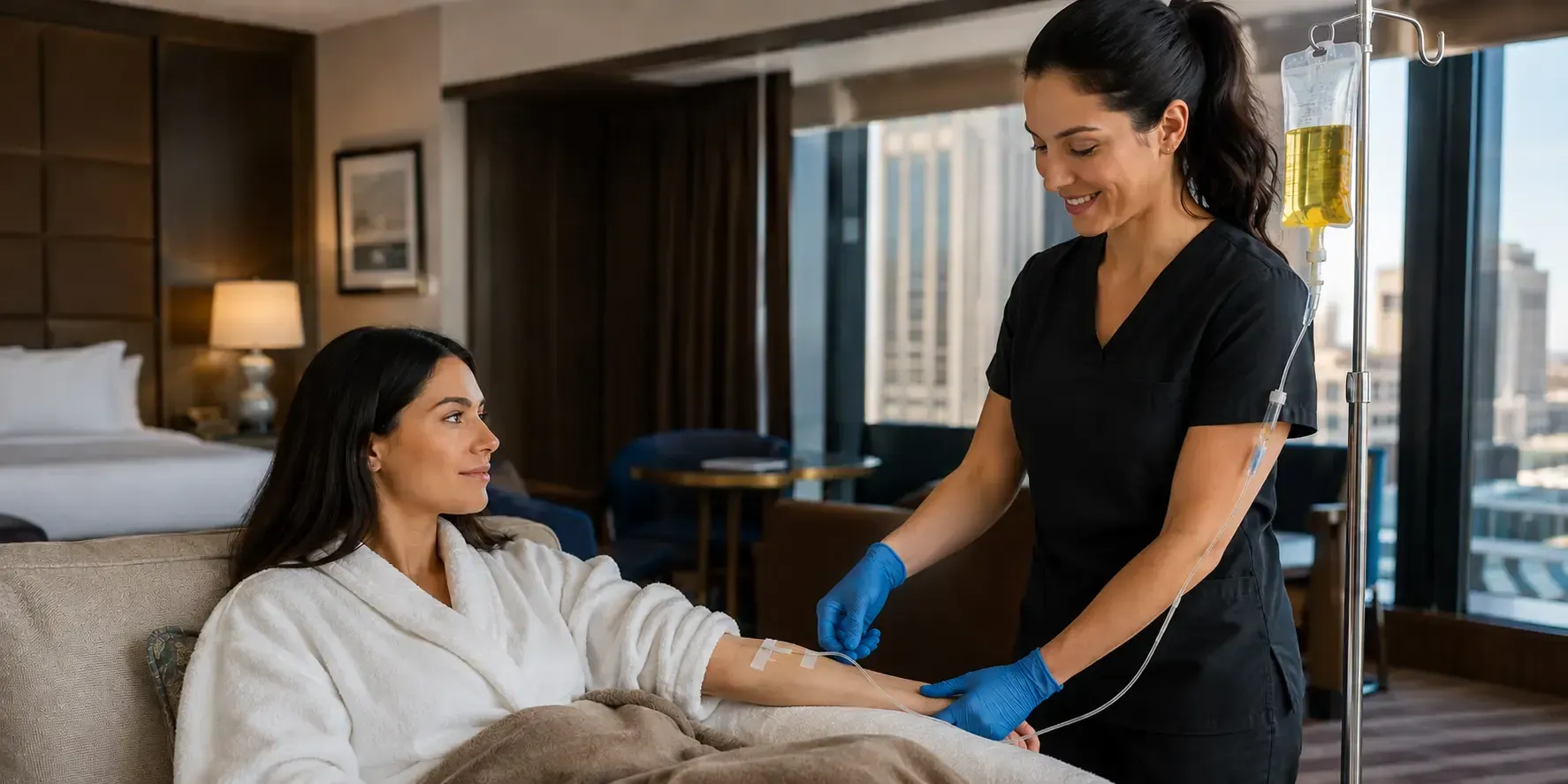 Mobile IV therapy service in a Las Vegas hotel room with a nurse assisting a woman receiving IV hydration.