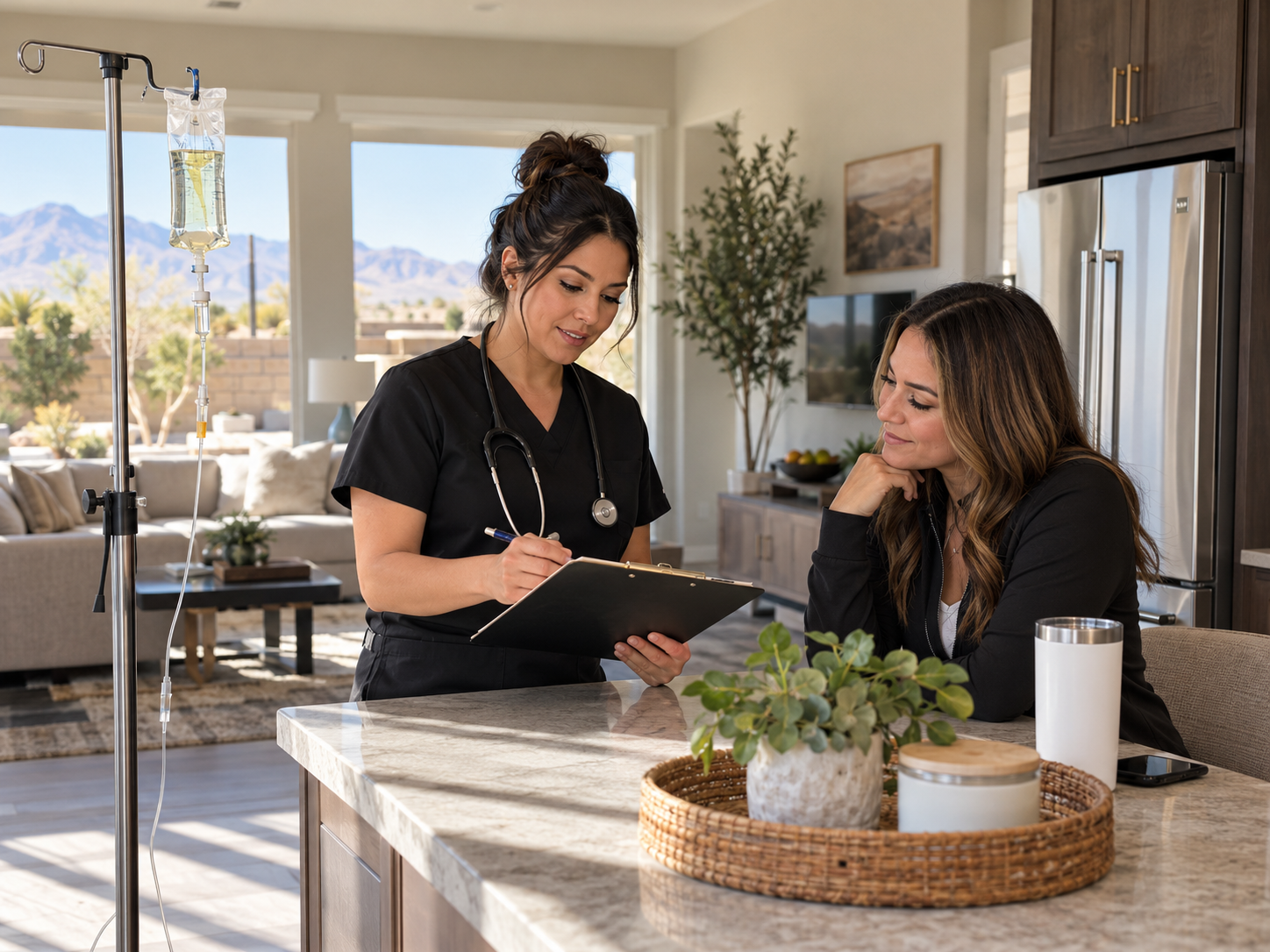 Two women review a tablet at a kitchen island in a bright home with mountain views.