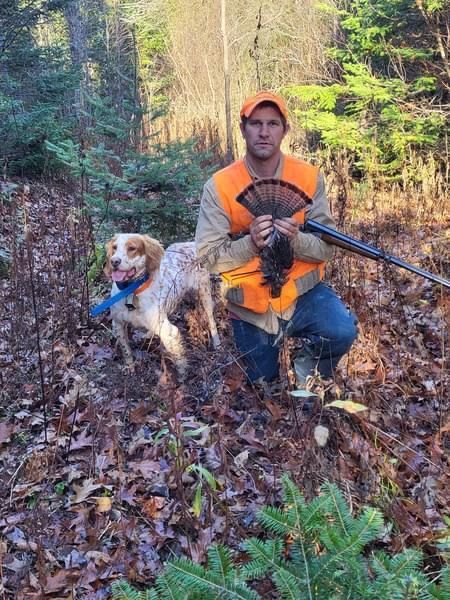 hunter with grouse in maine