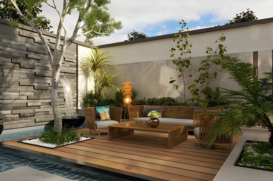 Modern courtyard patio with wooden deck, stone wall, lush plants, and outdoor seating under soft light
