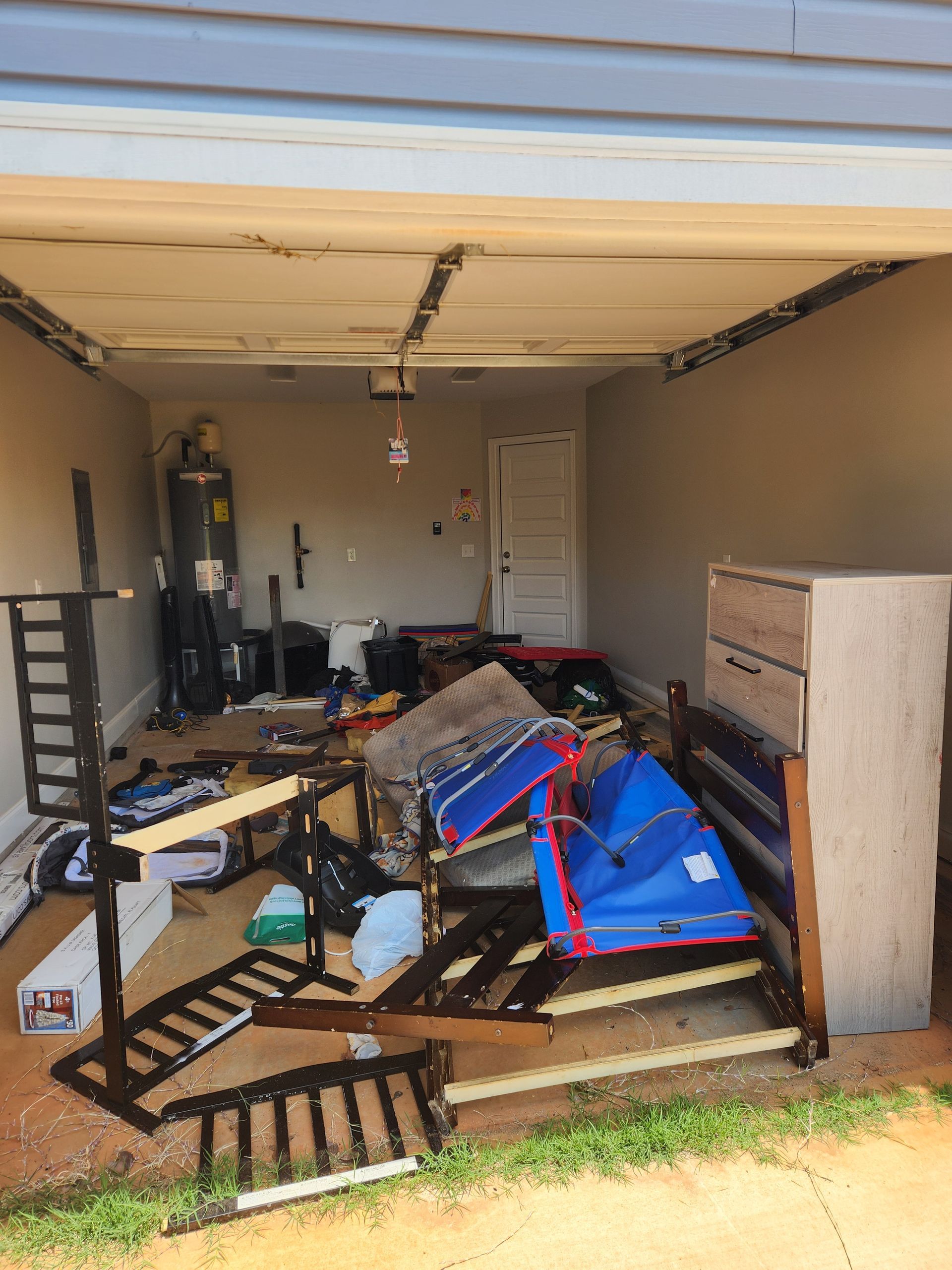 Garage full of residential junk like old furniture and boxes.