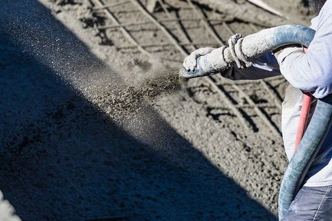 someone pouring the concrete cement