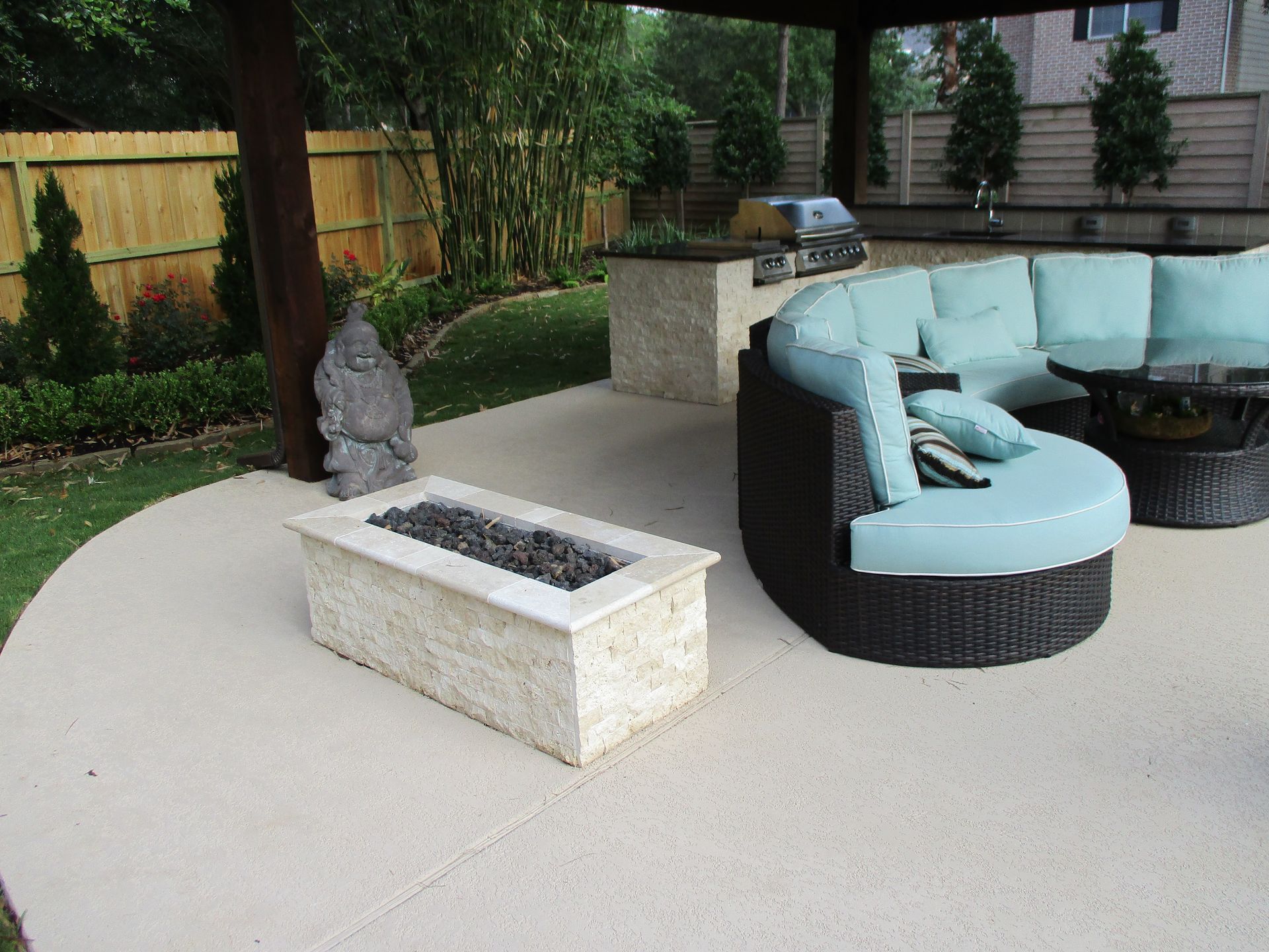 A patio with a fire pit and a couch