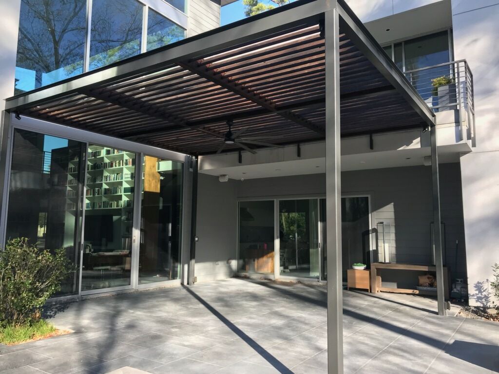 A large building with a pergola in front of it