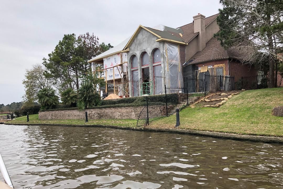 A house is being built next to a body of water.