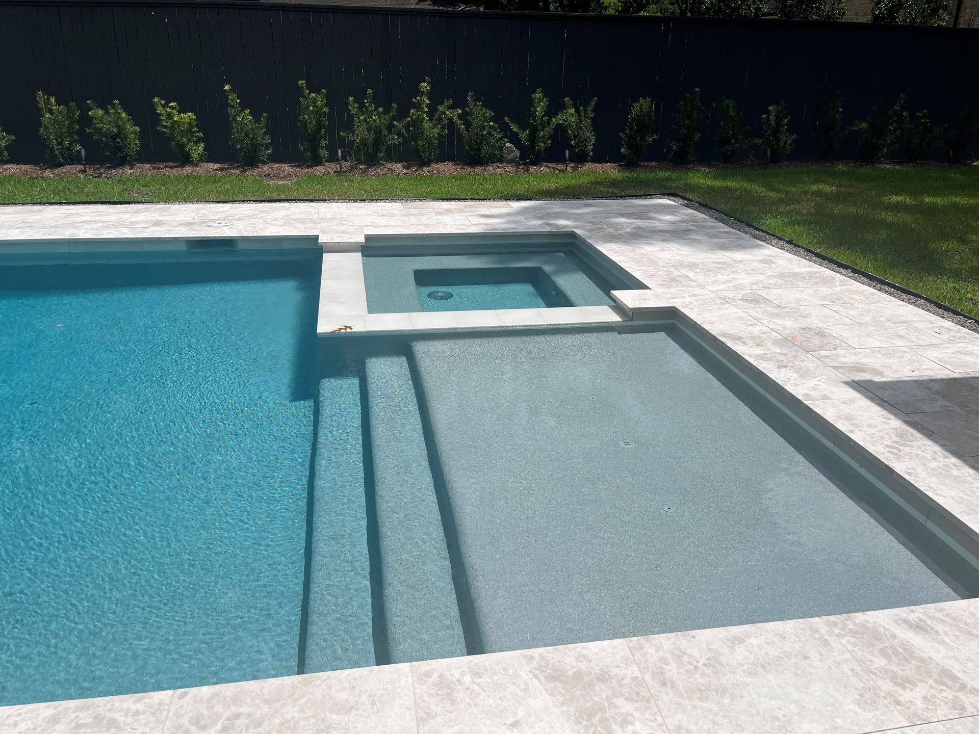 A large swimming pool with stairs leading up to it