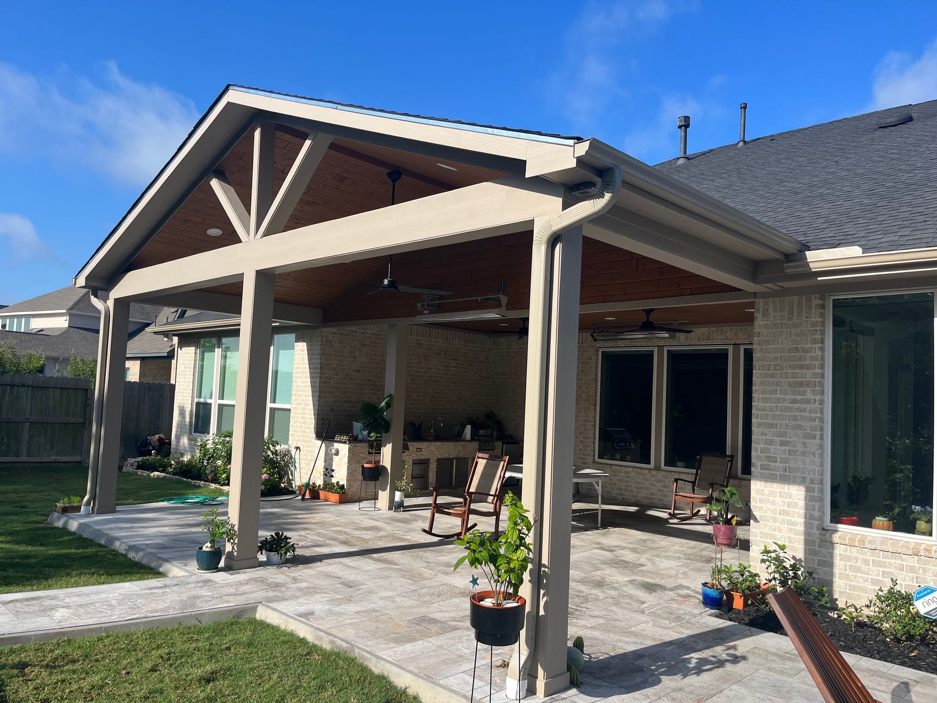 A house with a large covered patio in front of it.