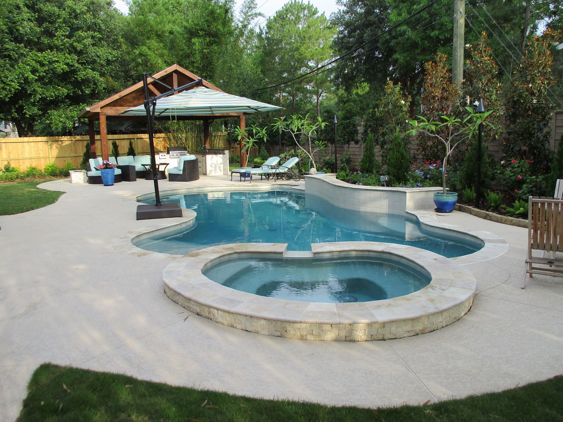 A large swimming pool with a hot tub in the middle