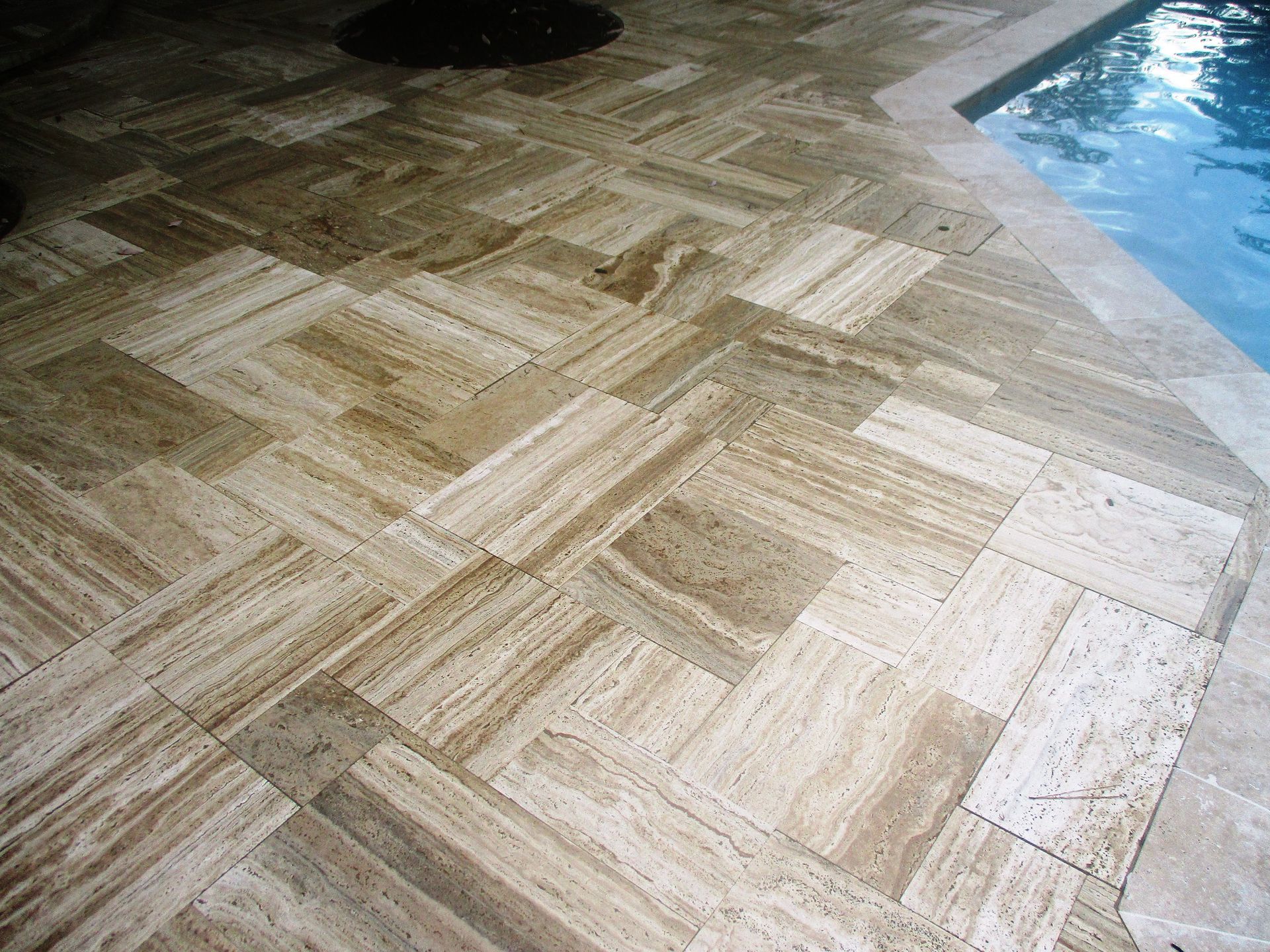 A swimming pool with a tiled floor next to it