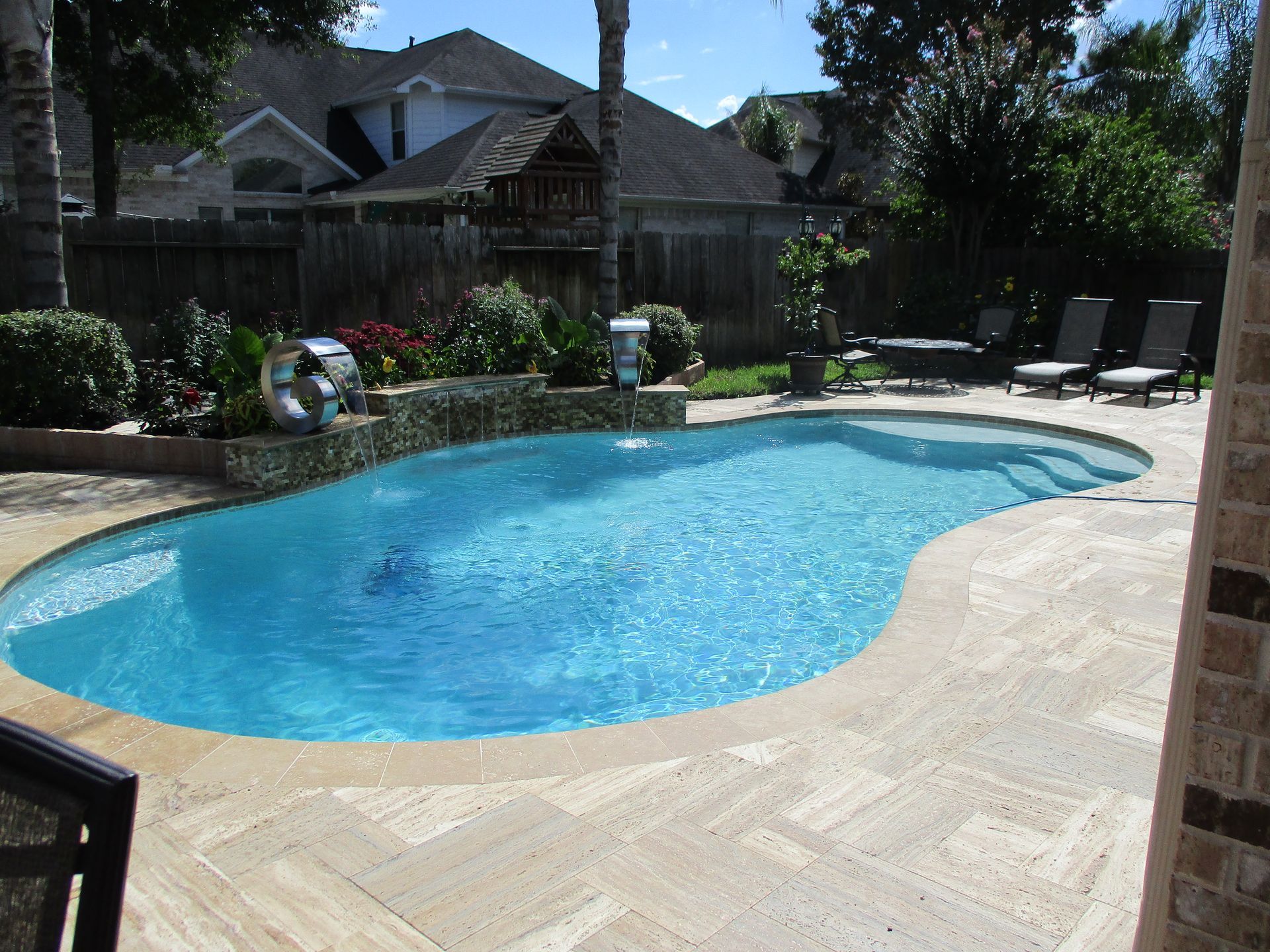 A large swimming pool in the backyard of a house