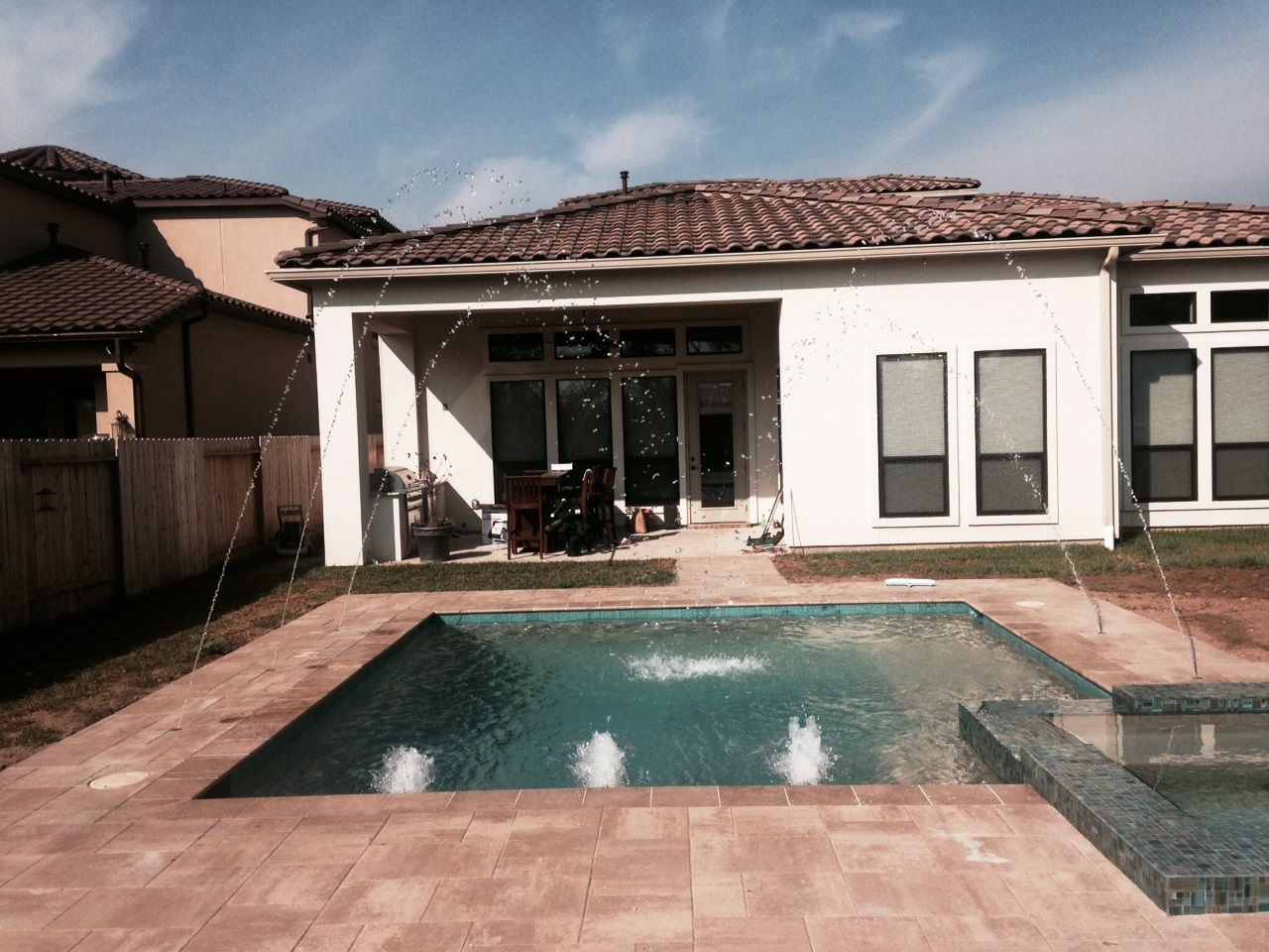 A house with a swimming pool in front of it