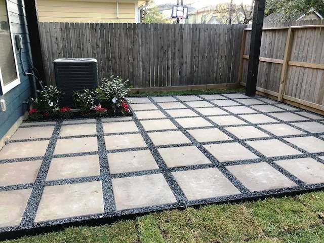 A patio with a wooden fence in the background