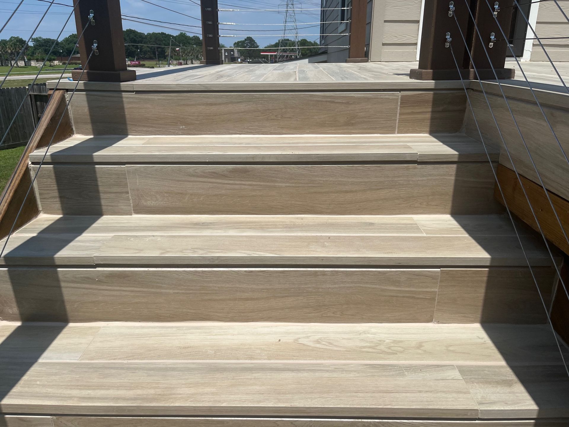 A set of wooden stairs leading up to a deck.
