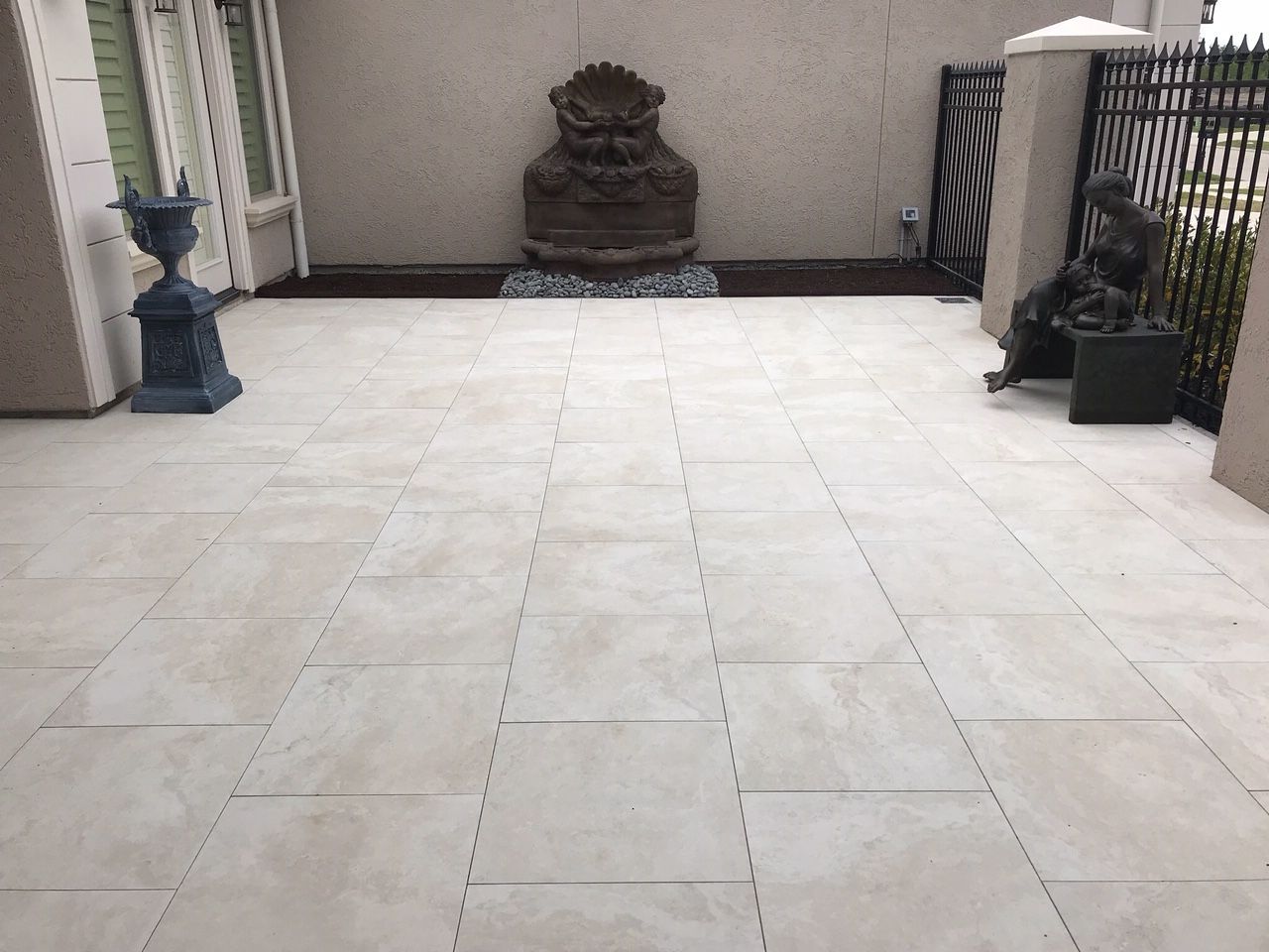 A white tiled floor with a statue in the middle of it.