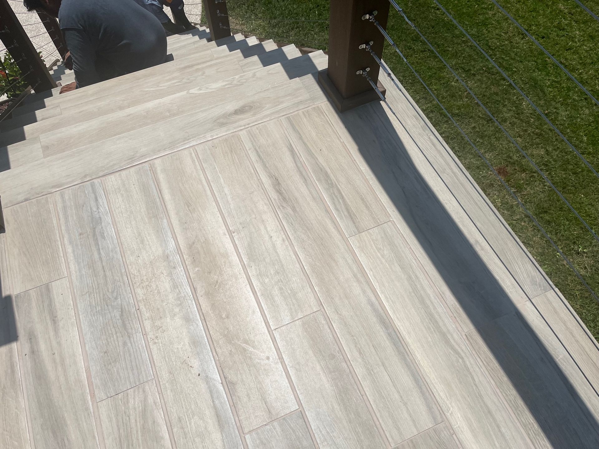 A wooden deck with stairs leading up to it.
