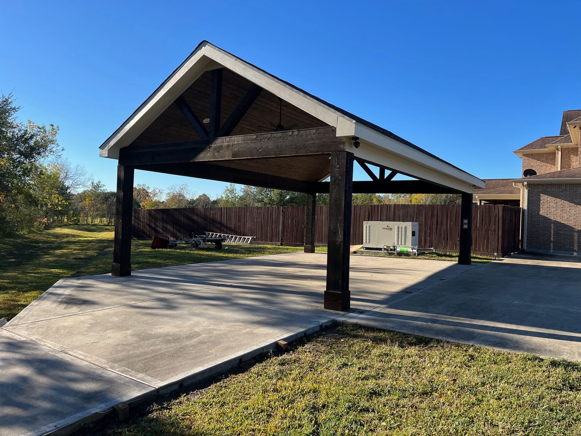 There is a carport in the backyard of a house.