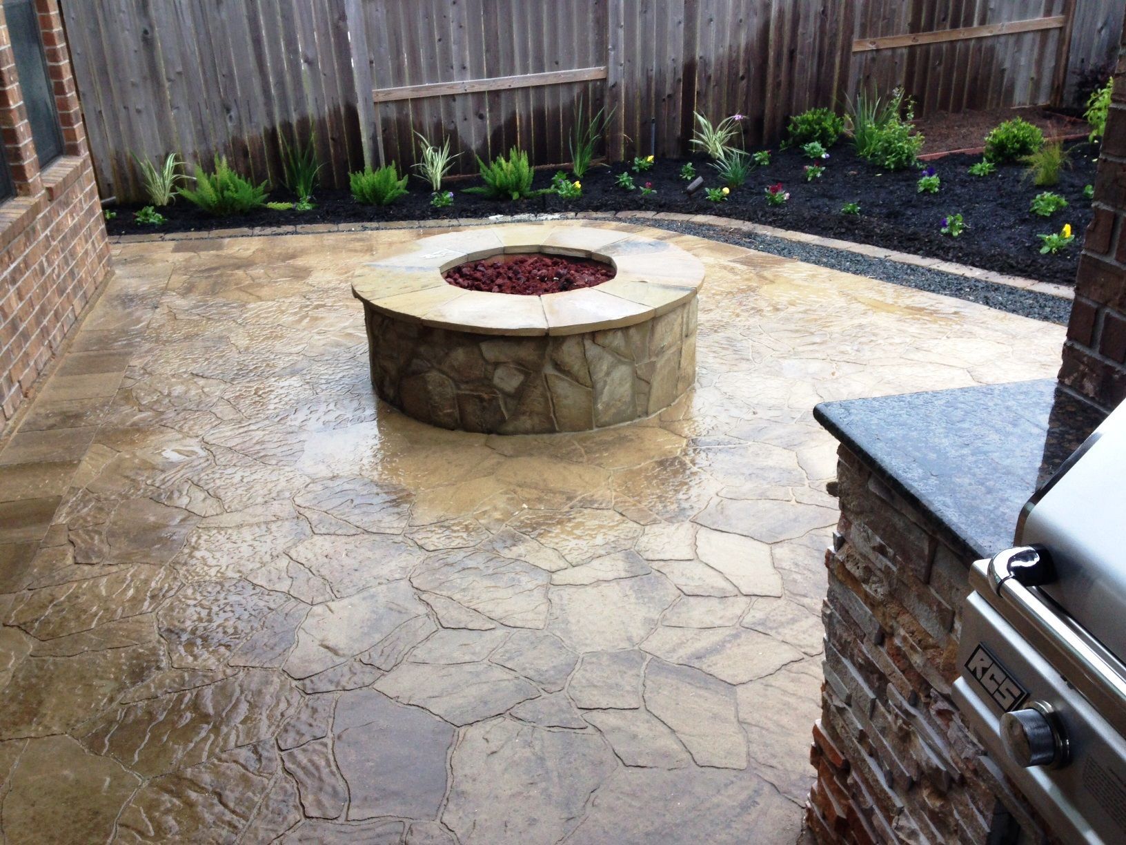 There is a fire pit in the middle of the patio.