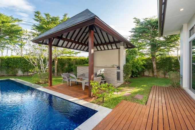 There is a gazebo next to a swimming pool.