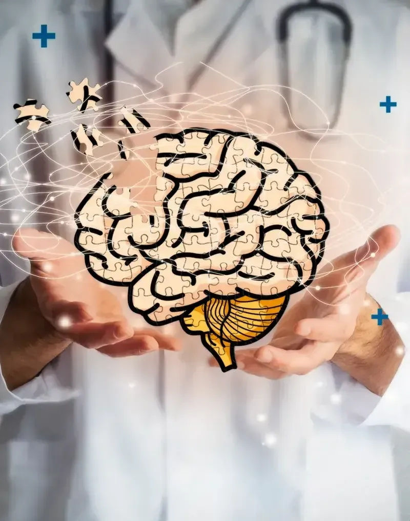 Un médico sostiene en sus manos un cerebro hecho de piezas de rompecabezas.