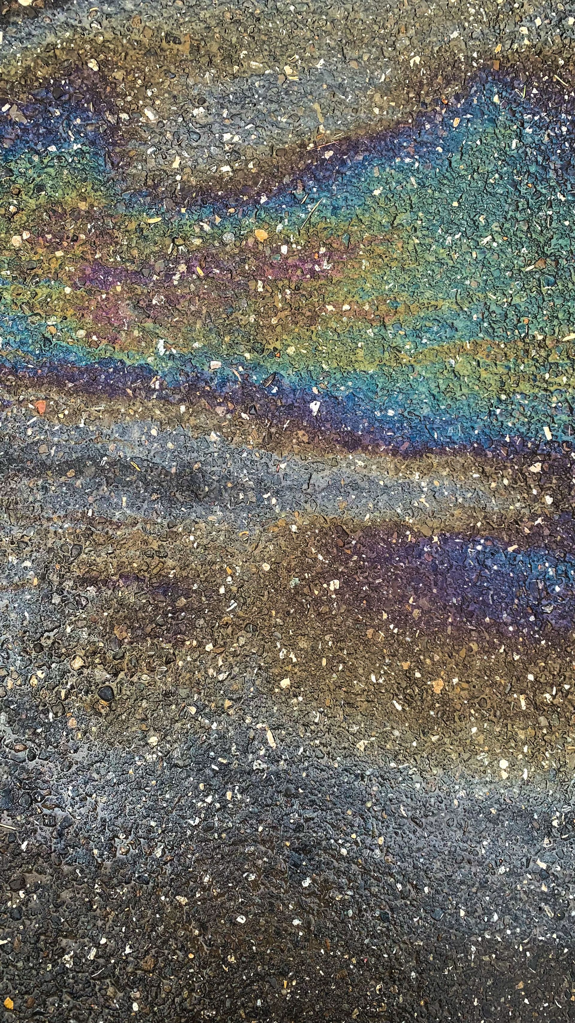 Abstract close-up of shimmering sand with iridescent blue, green, and purple bands
