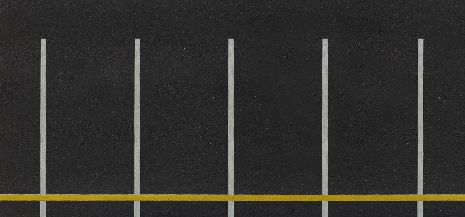 Line striping machine painting white lines on asphalt. Line striping machine painting white lines on asphalt.
