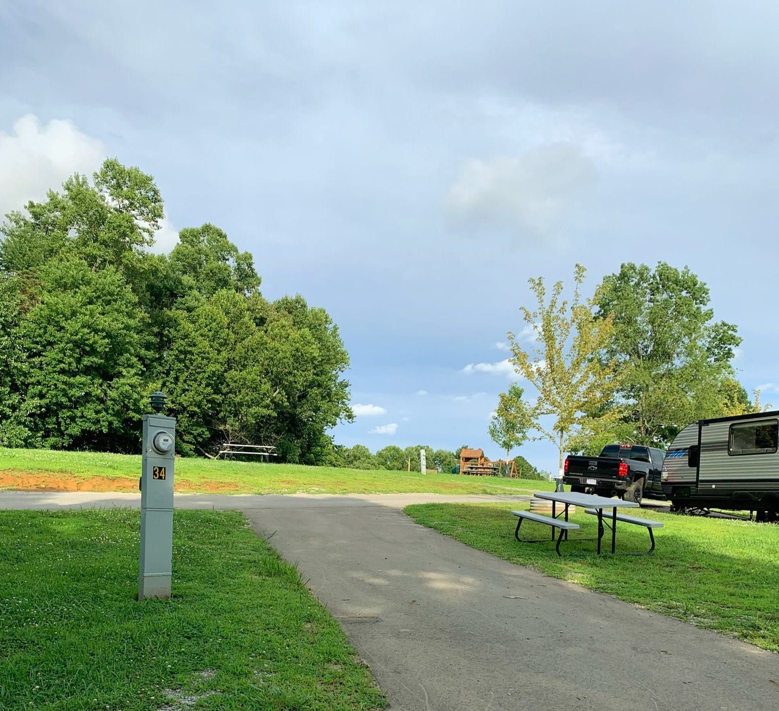 a rv parked in a grassy area with a picnic table