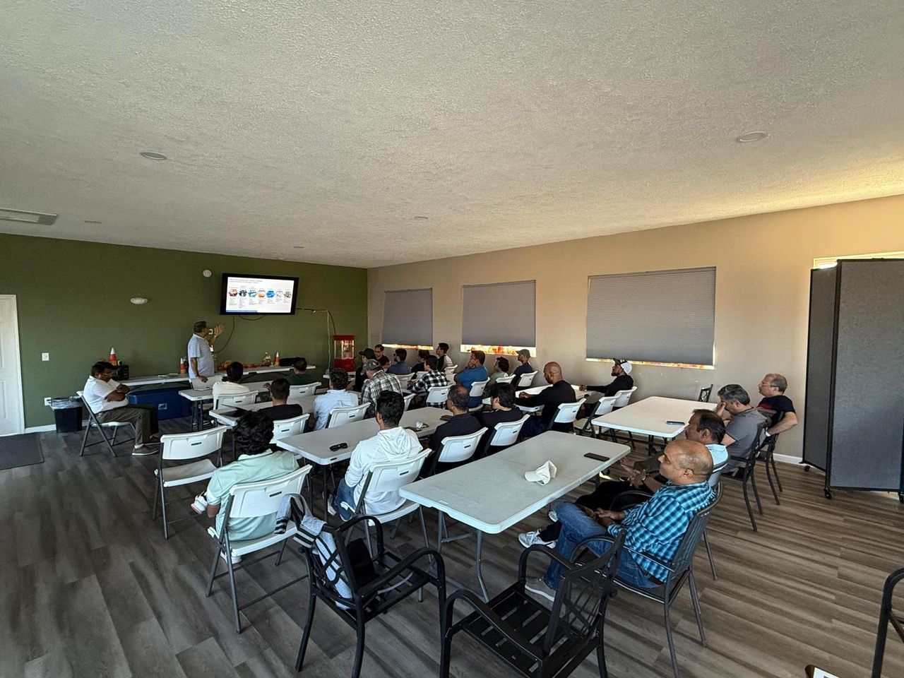A group of people are sitting at tables in a room.