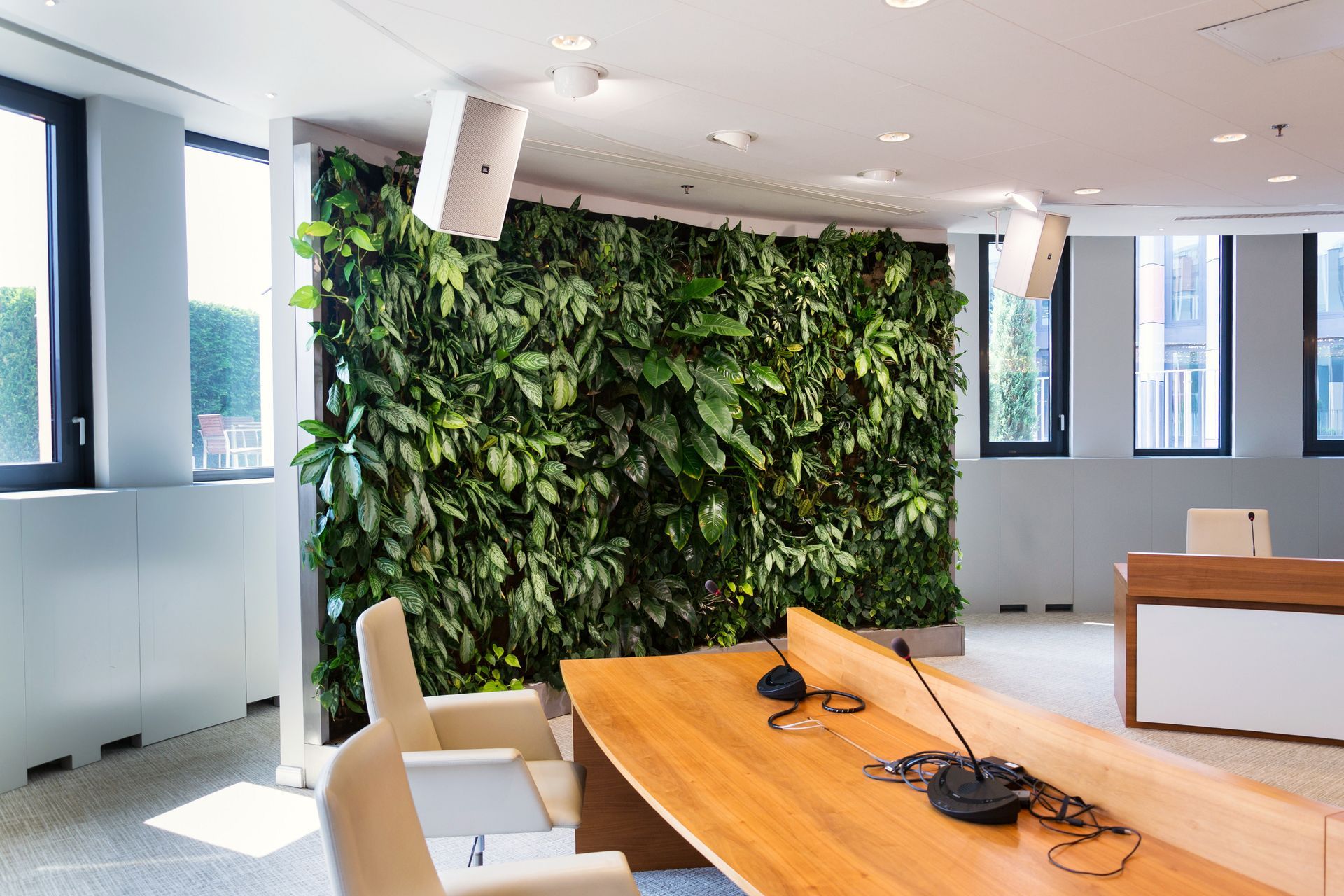 Living green wall indoors with flowers and plants in a meeting boardroom. Living green wall indoors with flowers and plants in a meeting boardroom.