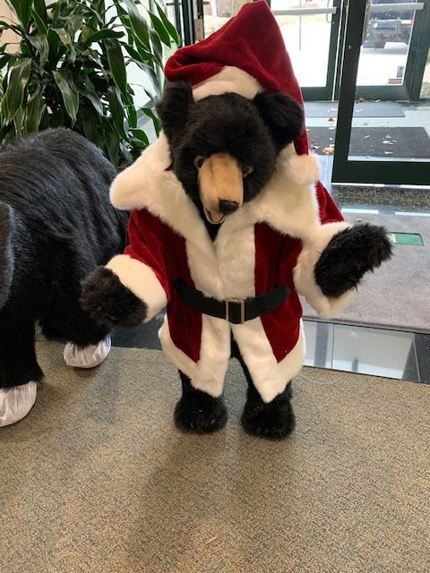 Standing smiling Santa black bear.