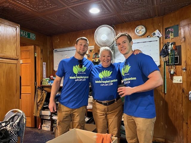 Three People In Matching Blue Shirts.