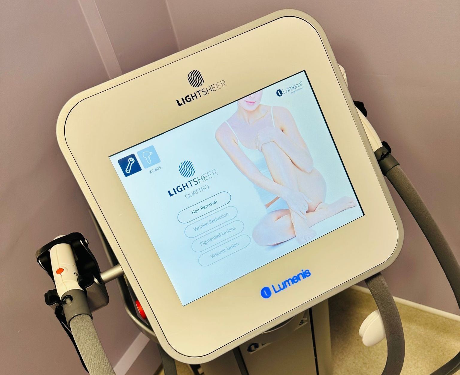 Laser hair removal machine with touch screen showing a woman, the Lightsheer Lumina brand is visible.