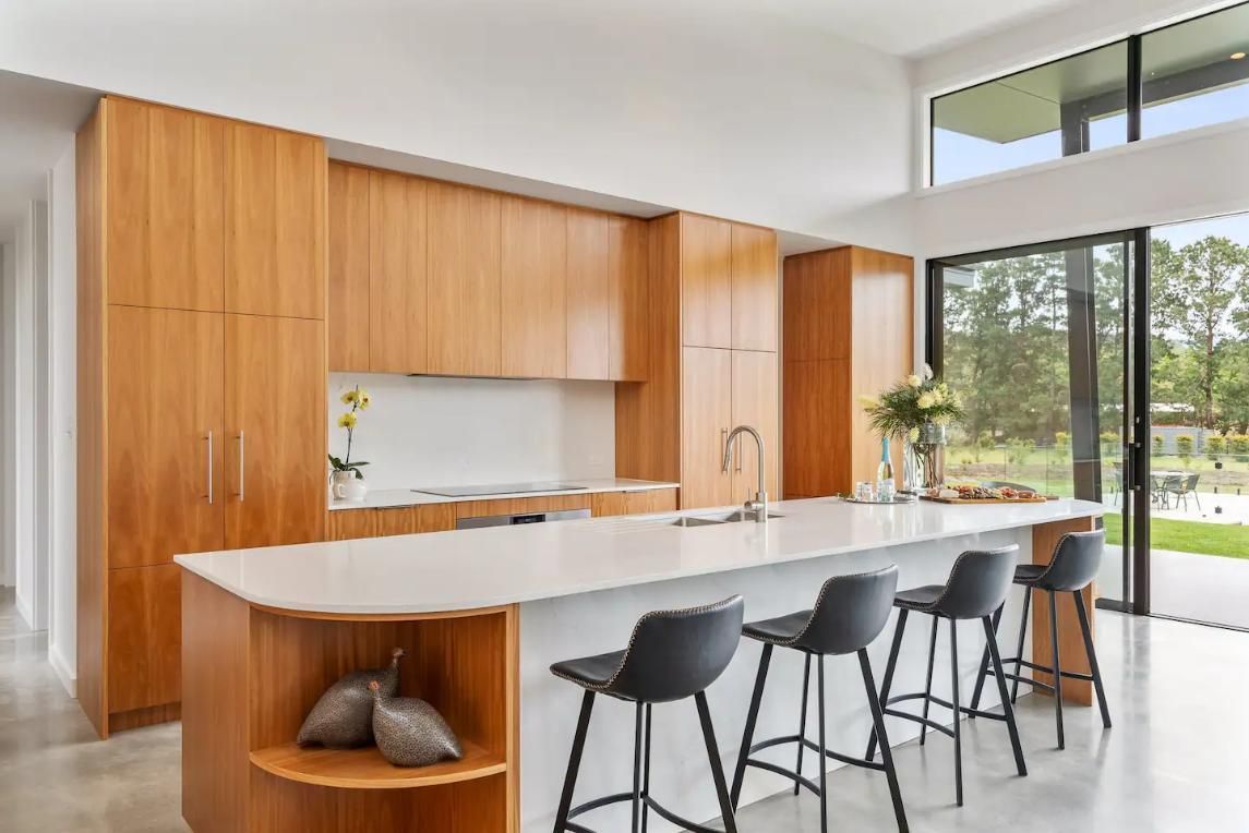 A Kitchen With Wooden Cabinets , A Large Island , and Stools — That Painter Guy In South Nowra, NSW