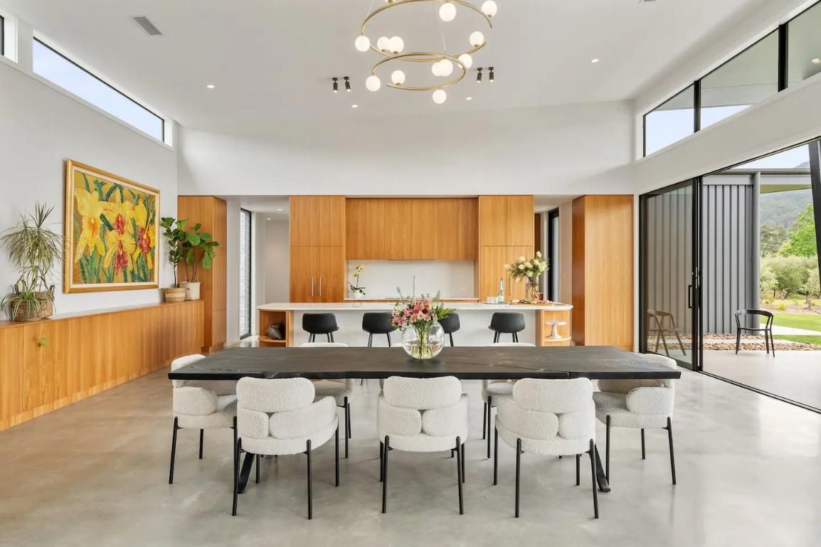 A Dining Room With A Long Table and Chairs and A Kitchen In The Background — That Painter Guy In South Nowra, NSW