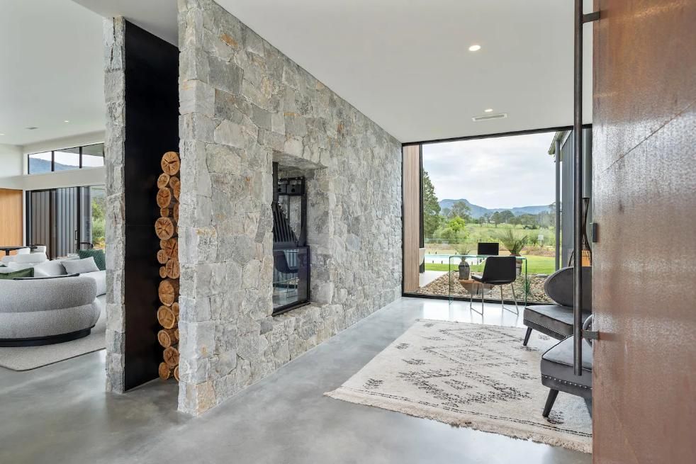 A Living Room With A Stone Wall and A Large Window — That Painter Guy In South Nowra, NSW