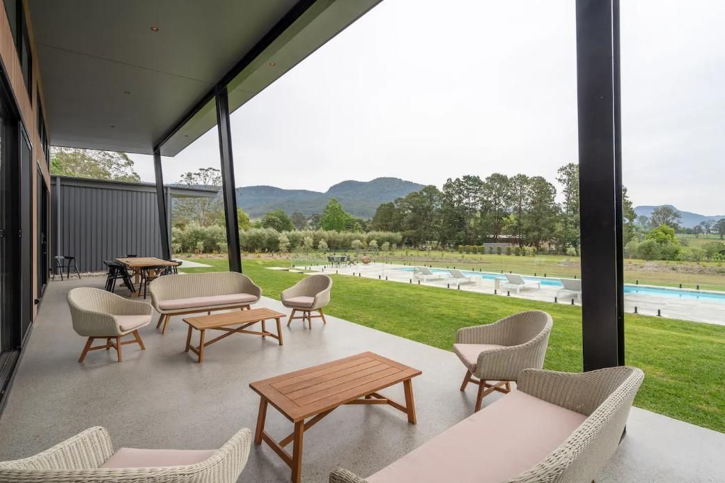 A Patio With A Lot Of Furniture and A Swimming Pool In The Background — That Painter Guy In South Nowra, NSW