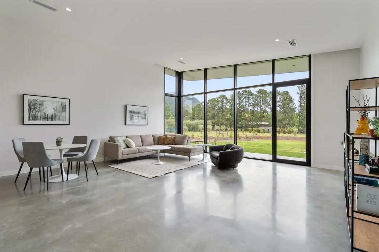 A Living Room With A Couch , Table , Chairs and A Large Window — That Painter Guy In South Nowra, NSW