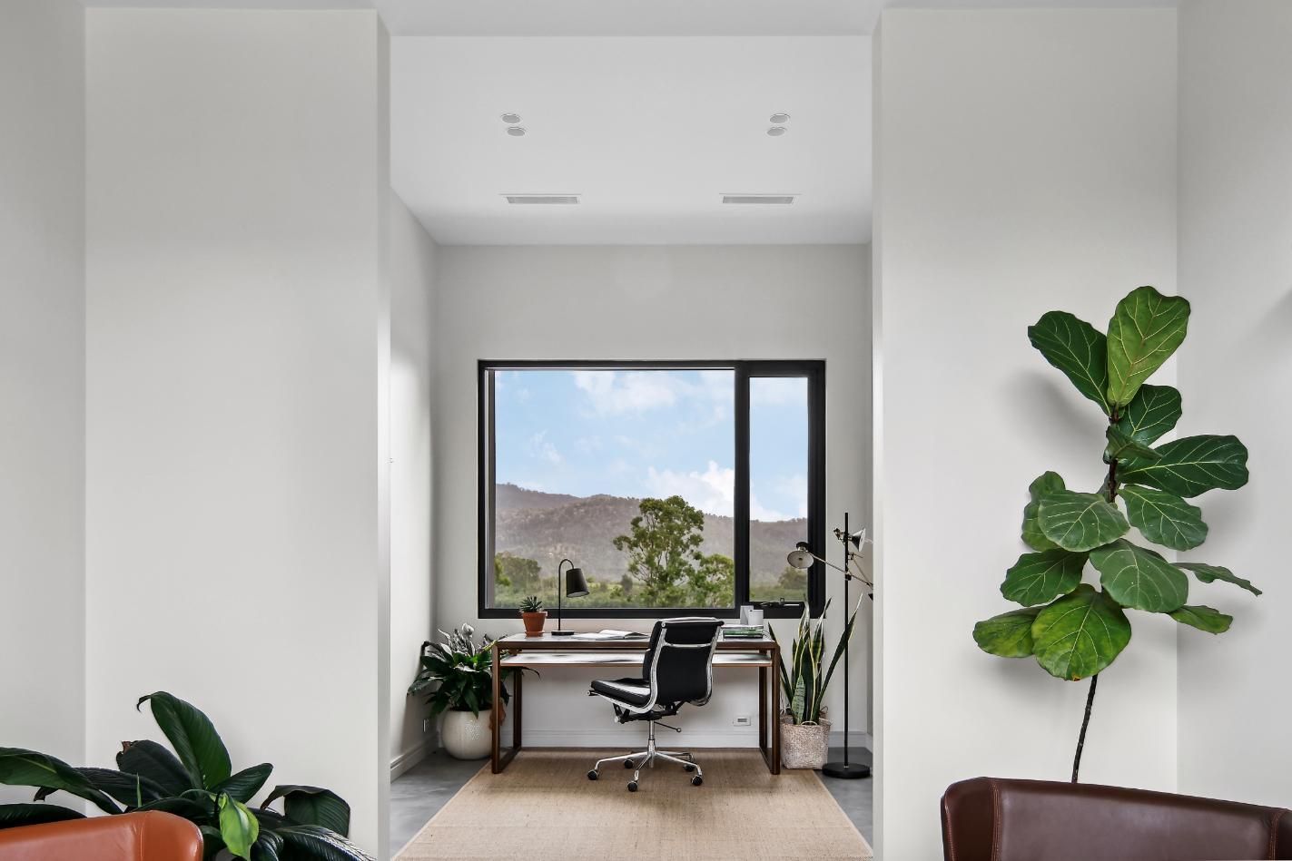 A home office with a desk and chair in front of a large window.— That Painter Guy In Vincentia, NSW