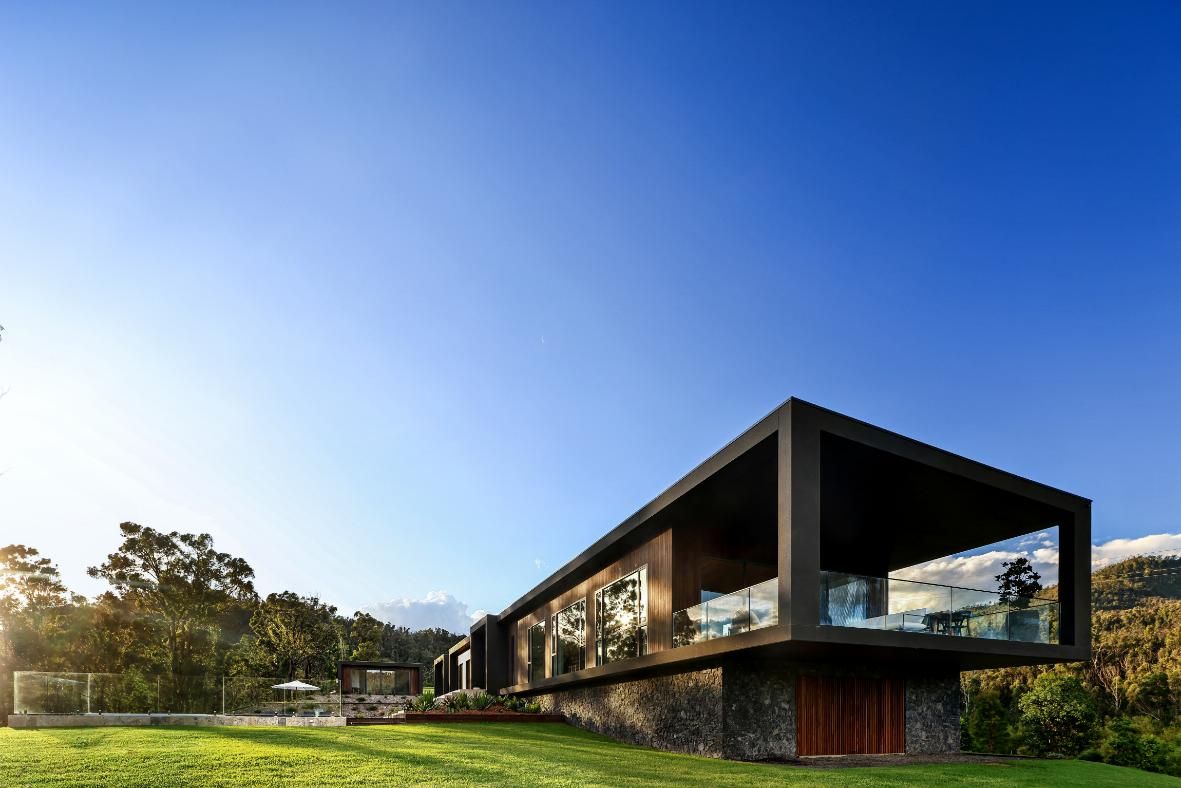 A Modern House Is Sitting On Top Of A Lush Green Hillside — That Painter Guy In South Nowra, NSW