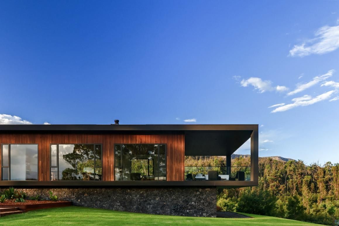 A Modern House Is Sitting On Top Of A Lush Green Hillside — That Painter Guy In South Nowra, NSW