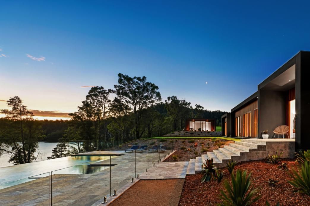 A Modern House With Stairs Leading Up To A Lake Surrounded By Trees — That Painter Guy In South Nowra, NSW