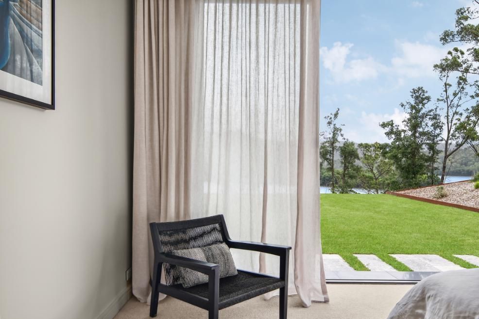 Bedroom With A Chair and A Sliding Glass Door Leading To A Lawn — That Painter Guy In South Nowra, NSW