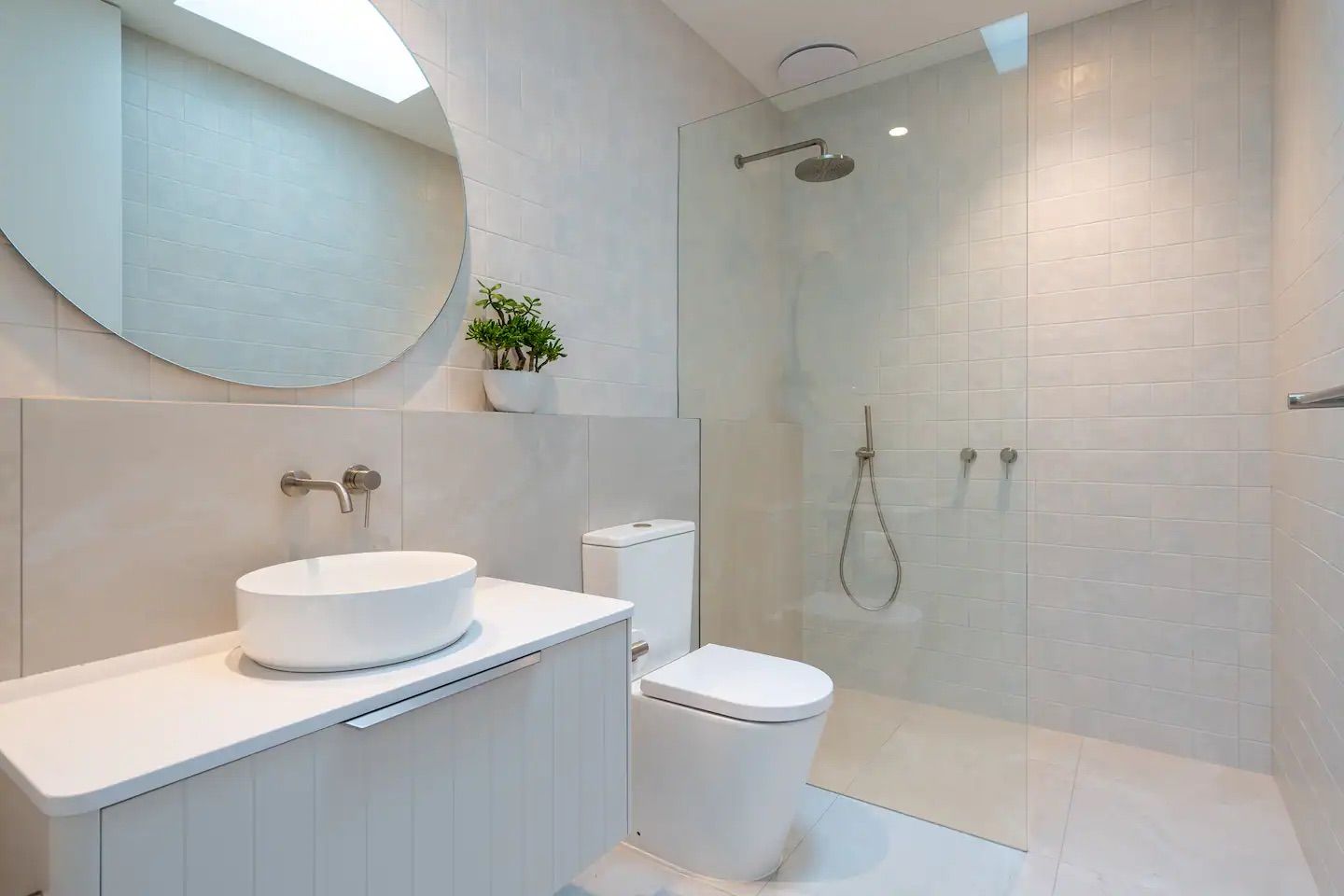 A bathroom with a toilet , sink , mirror and walk in shower. — That Painter Guy In South Nowra, NSW