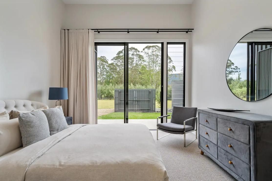 A Bedroom With A Large Bed , Dresser , Chair and Mirror — That Painter Guy In South Nowra, NSW