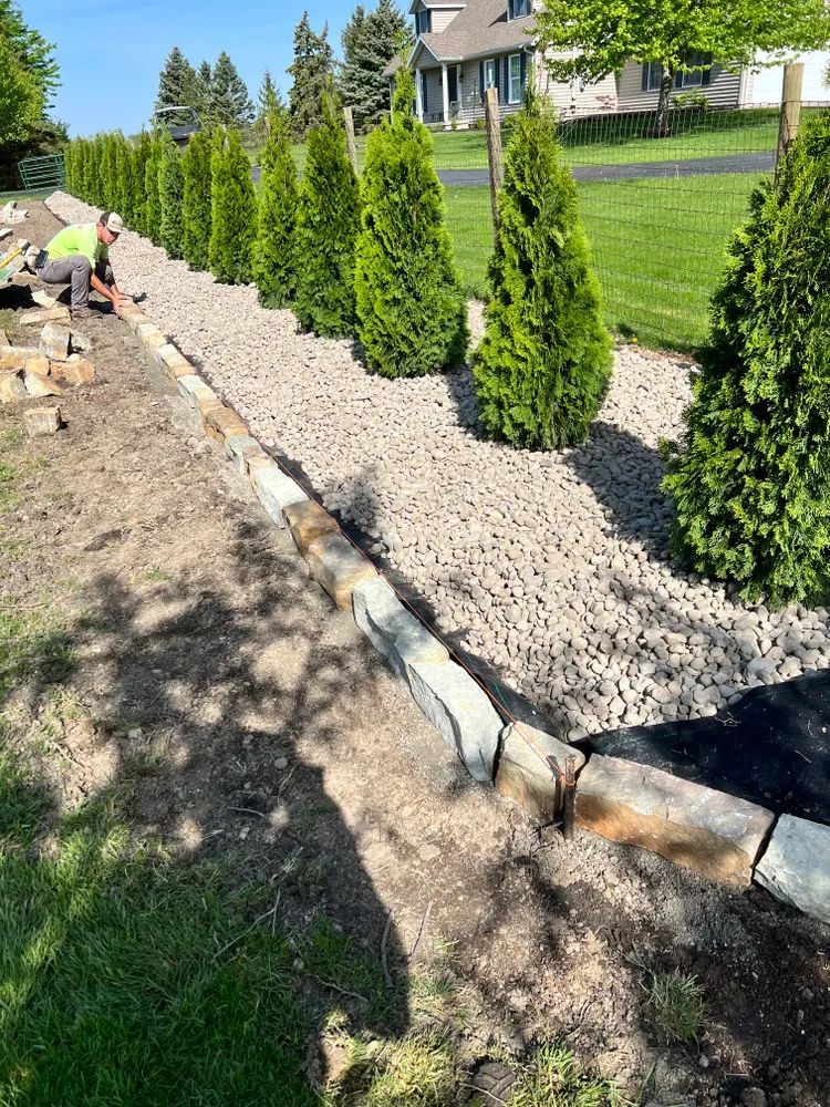 A man is working on a landscaping project in a yard.